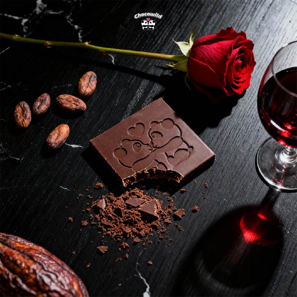 A flat lay of dark chocolate and romantic elements, representing the best chocolate for mood and intimacy.
